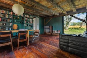 a room with a table and chairs and bookshelves at Valley View - Renovated Cottage New Addon and Pool in Copake