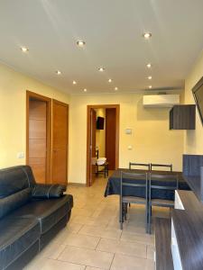 a living room with a couch and a table at Apartaments Tramuntana in Port de la Selva