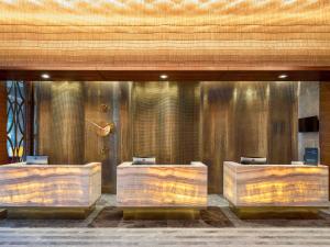 a row of wooden tables in a room at Mövenpick Hotel & Thermal Spa Bursa in Bursa