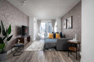 a bedroom with a bed and a television in it at Modern King Suite Steps to Eaton Centre in Toronto +20 photos