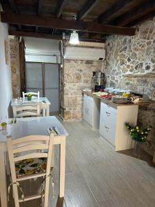 a kitchen with a counter and a table in a room at Ayvalık 1892 Konukevi in Ayvalık