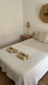 a bedroom with a bed with two pillows on it at Brisa de Milfontes in Vila Nova de Milfontes