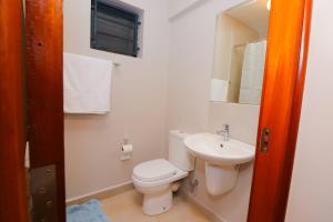 a white bathroom with a toilet and a sink at Kasarani trm in Nairobi +80 photos