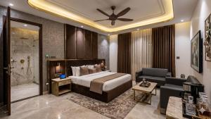a hotel room with a bed and a bathroom at Hotel The Caves Near IGI Airport Delhi in New Delhi