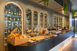 a buffet line with food and drinks in a restaurant at JD Village in Itapema