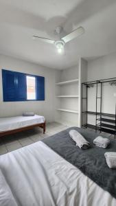 a bedroom with a large bed with two pillows on it at Casa Estrela Azul in Pitimbu +50 photos