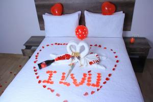 a bed with a heart made out of red hearts at Kgajane Guest House in Molepolole +1 photo