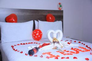 a bed with a heart made out of red hearts at Kgajane Guest House in Molepolole