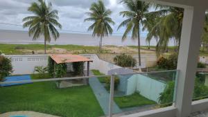 a view of the beach from the balcony of a house at Casa Estrela Azul in Pitimbu