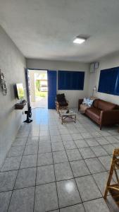 a living room with a couch and a table at Casa Estrela Azul in Pitimbu