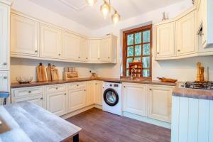 a kitchen with white cabinets and a dishwasher at 3 Bed in Blackburn oc-96386 in Blackburn