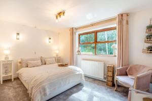a bedroom with a bed and a chair and a window at 3 Bed in Blackburn oc-96386 in Blackburn
