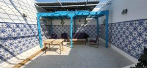 a room with blue and white tiles on the wall at Dar EMNA in Kairouan