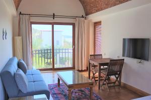 a living room with a blue couch and a table at Munahan Otel in Bodrum City