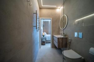 a bathroom with a toilet and a sink and a mirror at The Simon Residences - Marina Escape in Olhão +37 photos