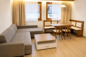 a living room with a couch and a table at Appartements MAGLOV in Bad Kleinkirchheim +43 photos