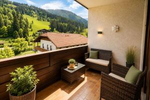 a balcony with two chairs and a table with a view at Appartements MAGLOV in Bad Kleinkirchheim