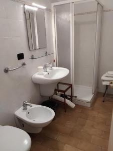 a bathroom with a sink and a toilet and a shower at B&B Fattore in Levanto +36 photos