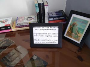 a pile of books sitting on top of a table at B&B Fattore in Levanto