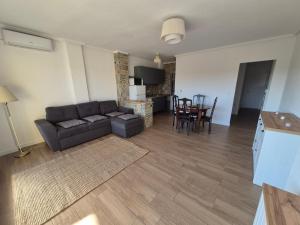 a living room with a couch and a table at Playa Los Náufragos Torrevieja in Torrevieja +6 photos