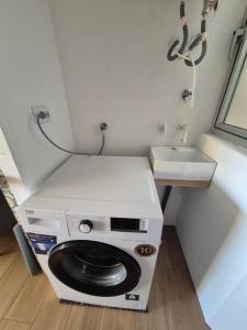 a small bathroom with a toilet and a sink at Playa Los Náufragos Torrevieja in Torrevieja