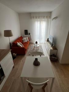 a living room with a couch and a table at Céret hyper centre - Cozy T2 in Céret +6 photos