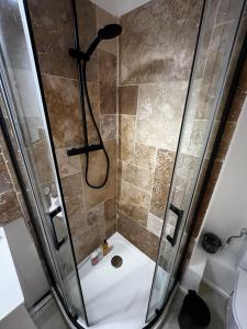 a bathroom with a shower with a shower head at Céret hyper centre - Cozy T2 in Céret