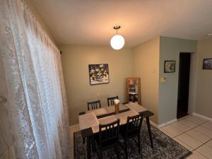 a dining room with a table and chairs at Cozy nest in Coquitlam