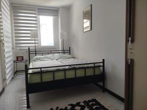 a bedroom with a bed and a window at Sky Vista in Železnička Stanica Tuzla