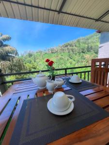 a wooden table with plates and cups on top of it at Tea Pick View Ella in Ella