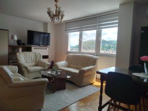 a living room with two chairs and a table at Sky Vista in Železnička Stanica Tuzla