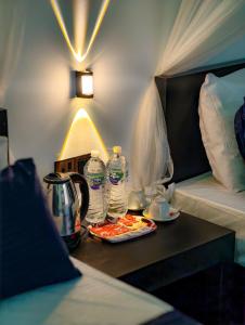 a hotel room with a table with water bottles on it at EMERALD HAVEN Safari Glamping in Udawalawe