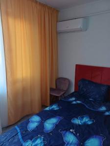 a bedroom with a bed with blue butterflies on it at Ibo in Brăila