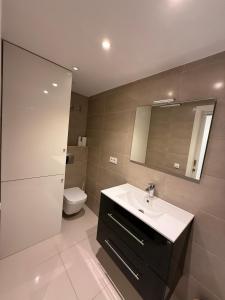 a bathroom with a sink and a toilet at AwayDays - 72 - Ocean View Studio in Empuriabrava +12 photos