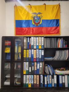 a flag is hanging above a shelf of books at Casa Colon Quito Bed & Breakfast Hostel in Quito +229 photos