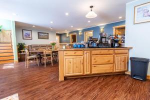 a kitchen and dining room with a counter and a table at Alaska Adventures Lodge in Seward +9 photos