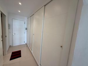 a large white room with a glass wall at AwayDays - 72 - Ocean View Studio in Empuriabrava