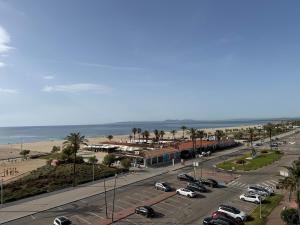 a parking lot next to a beach with cars parked at AwayDays - 72 - Ocean View Studio in Empuriabrava