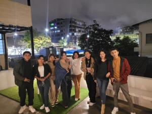 a group of people posing for a picture at night at Casa Colon Quito Bed & Breakfast Hostel in Quito