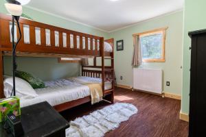 a bedroom with two bunk beds and a window at Alaska Adventures Lodge in Seward