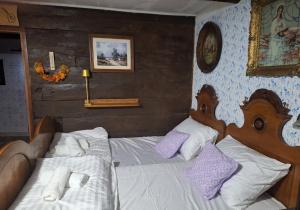 a bedroom with two beds in a room at Hiža Bake Veronike in Hrašćina