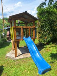 a playground with a blue slide and a gazebo at Hiža Bake Veronike in Hrašćina