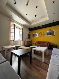 a living room with couches and tables in a room at Boutique Central Square Hostel in Trogir