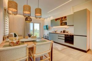 a kitchen and dining room with a table and chairs at Nyfida's four waves in Nifida