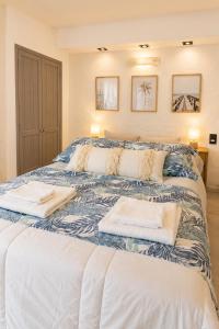 a bedroom with a large bed with towels on it at Despertá frente al mar! Loft con bajada privada! in Santa Clara del Mar