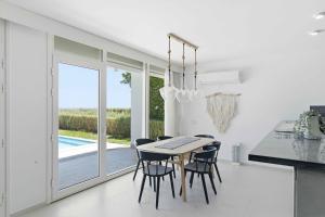 a kitchen and dining room with a table and chairs at Fouka Bay Holiday Apartments By BlueKeys in Marsa Matruh