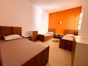 a bedroom with two beds and a window at Wostel Djerba Downtown in Houmt Souk +5 photos