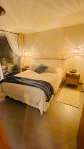 a bedroom with a large white bed in a room at Distrito Cavancha in Iquique +6 photos