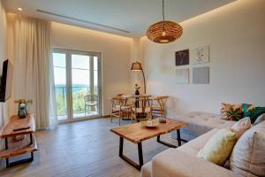 a living room with a couch and a table at Nyfida's four waves in Nifida