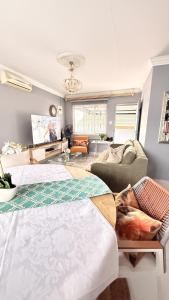 a living room with two beds and a couch at 33OnPangolin B&B in Nelspruit